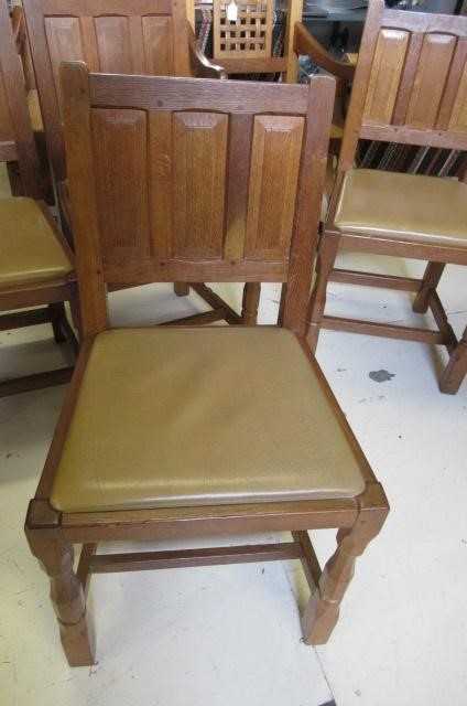 A COLIN ALMACK ADZED OAK DINING SUITE comprising multi panelled sideboard Image