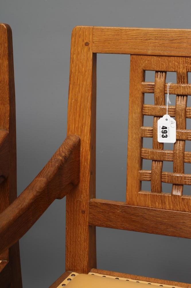 A PAIR OF ROBERT THOMPSON ADZED OAK ELBOW CHAIRS Image