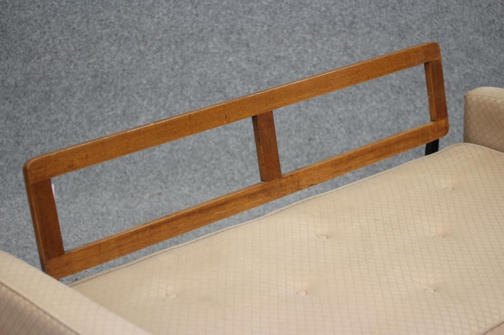 A TEAK AND IRON FRAMED SOFA BED Image