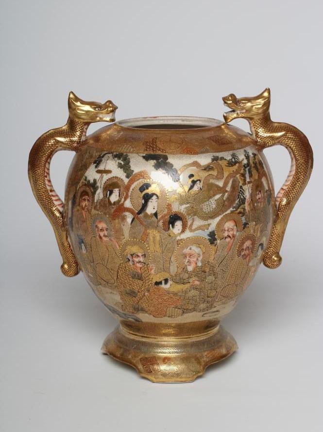 A SATSUMA EARTHENWARE VASE of rounded flared form with two dragon handles and raised upon a fixed Image