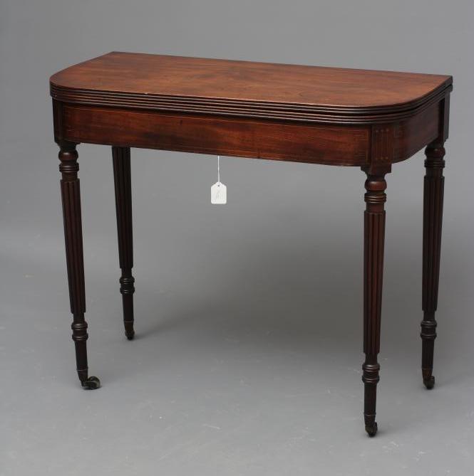 A REGENCY MAHOGANY FOLDING TEA TABLE of rounded oblong form with reeded edged top Image