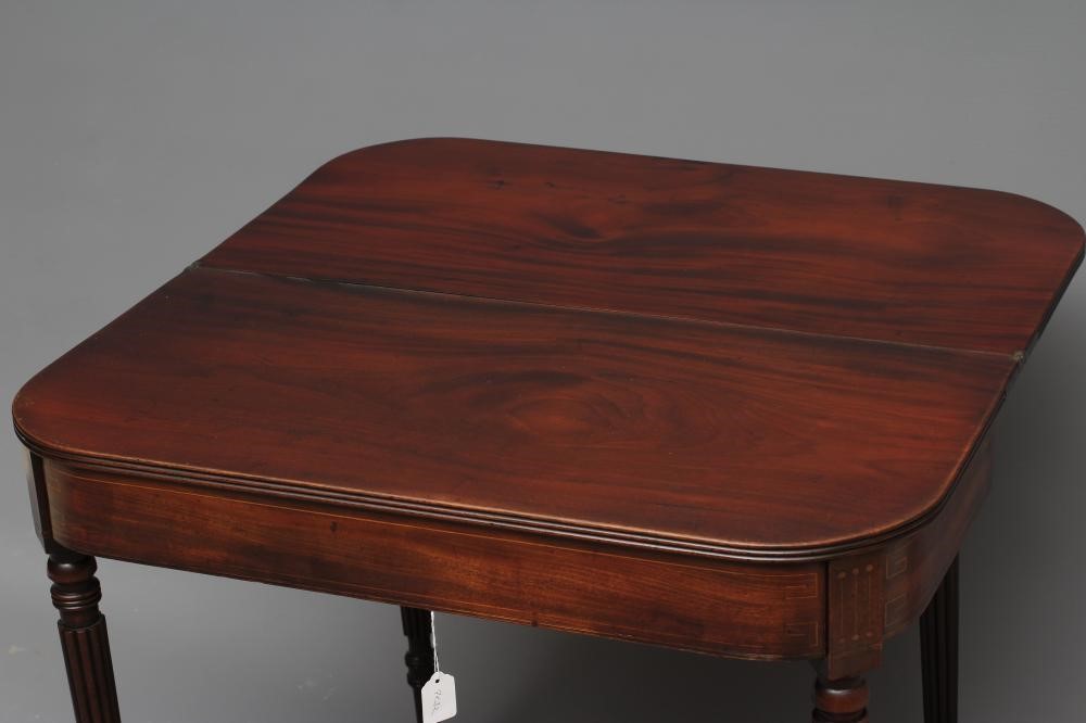 A REGENCY MAHOGANY FOLDING TEA TABLE of rounded oblong form with reeded edged top Image