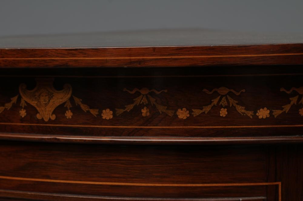 A LATE VICTORIAN ROSEWOOD AND MARQUETRY STANDING CORNER CUPBOARD of low bowed form with stringing Image