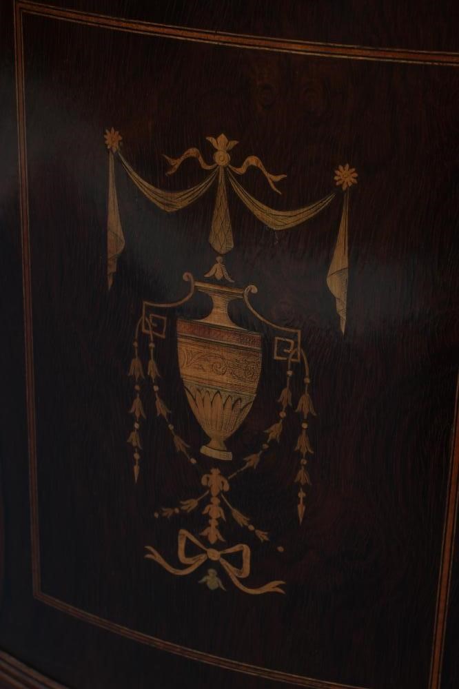 A LATE VICTORIAN ROSEWOOD AND MARQUETRY STANDING CORNER CUPBOARD of low bowed form with stringing Image