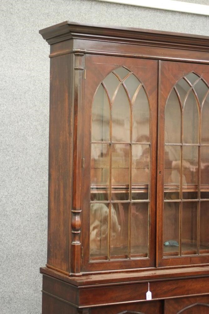 A LATE GEORGIAN GOTHIC MAHOGANY TWO STAGE BOOKCASE Image