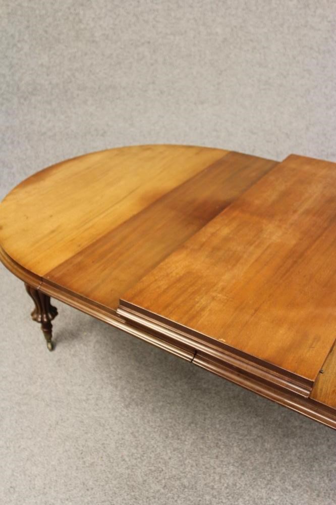 A VICTORIAN MAHOGANY EXTENDING DINING TABLE Image