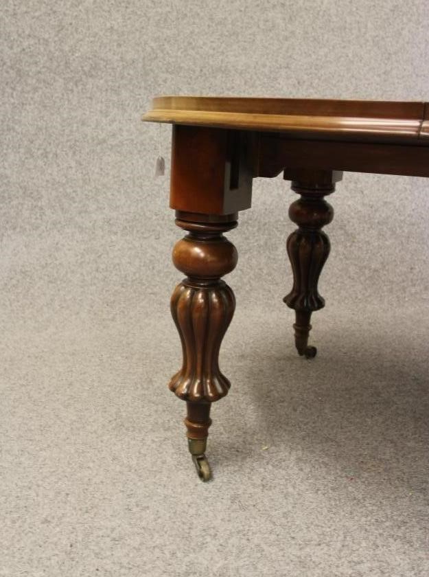 A VICTORIAN MAHOGANY EXTENDING DINING TABLE Image