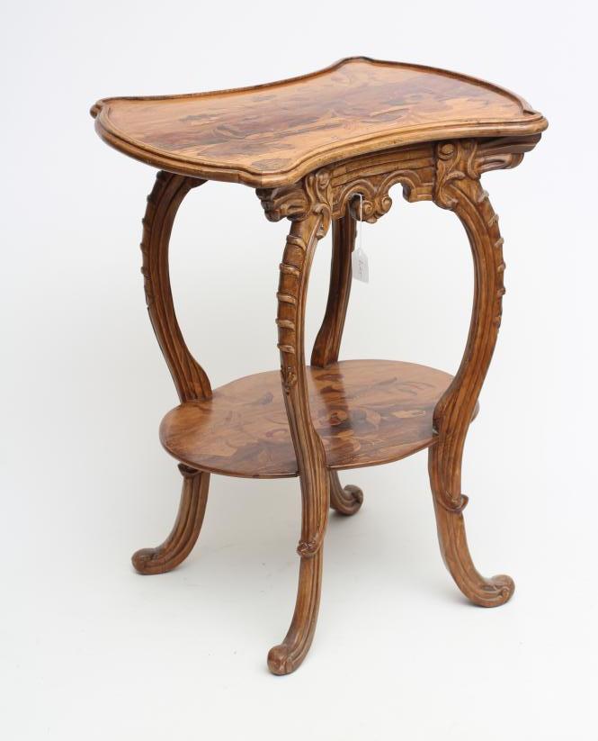A CARVED BEECH AND MARQUETRY OCCASIONAL TABLE in the style of Louis Majorelle Image