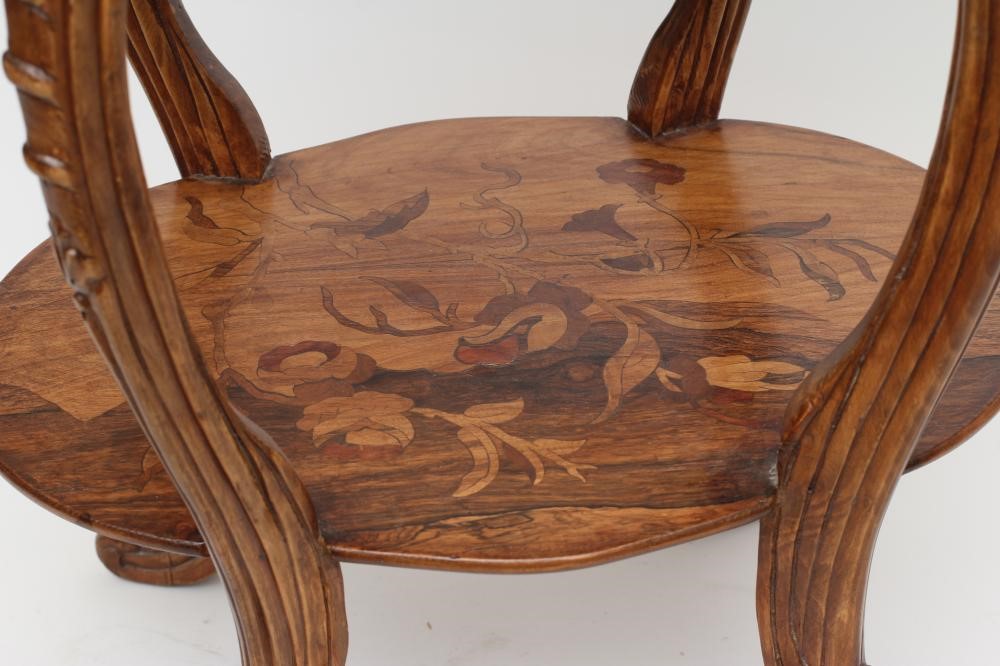 A CARVED BEECH AND MARQUETRY OCCASIONAL TABLE in the style of Louis Majorelle Image