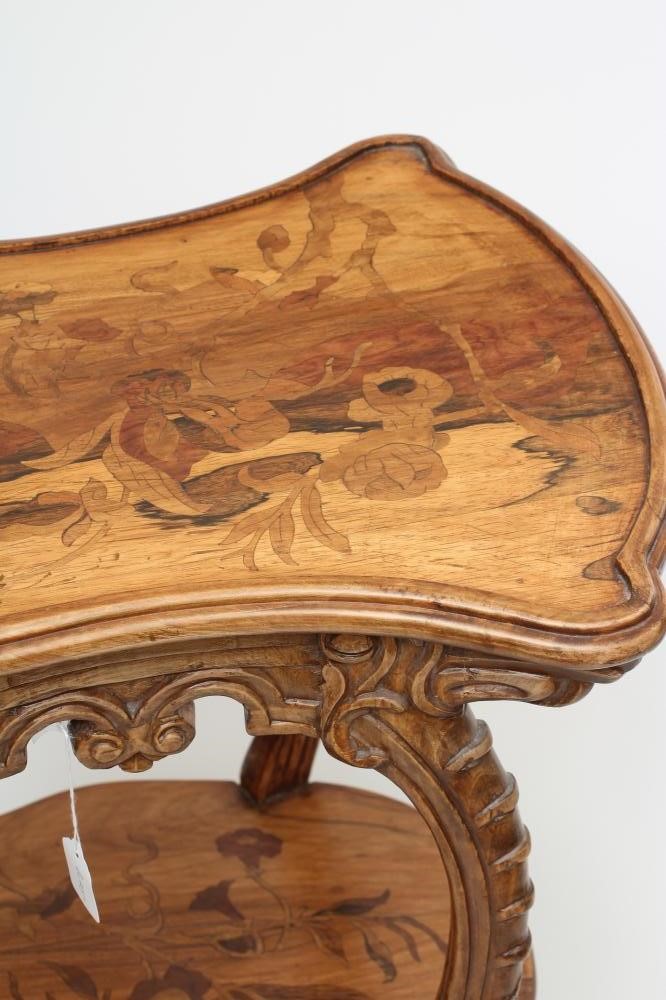 A CARVED BEECH AND MARQUETRY OCCASIONAL TABLE in the style of Louis Majorelle Image