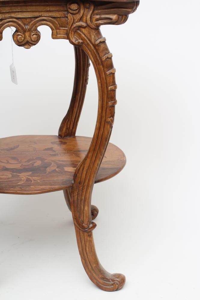A CARVED BEECH AND MARQUETRY OCCASIONAL TABLE in the style of Louis Majorelle Image
