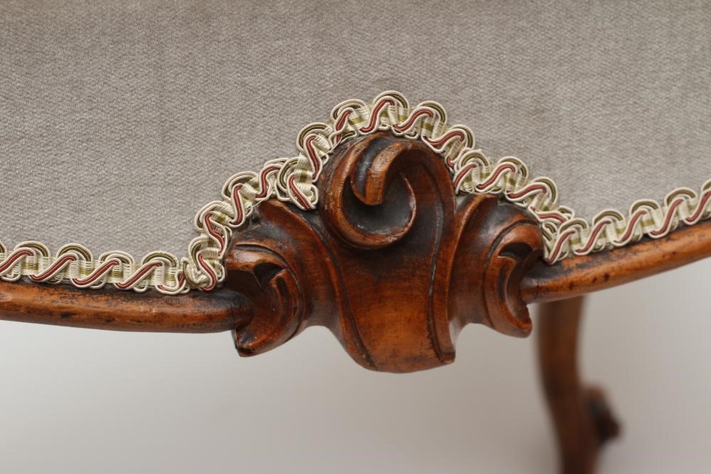 A VICTORIAN WALNUT DRESSING STOOL of long form with overstuffed seat in pale green floral gros point Image