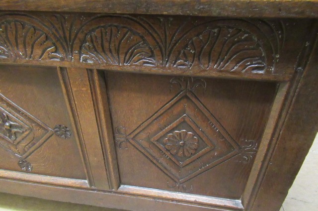AN OAK PANELLED COFFER Image