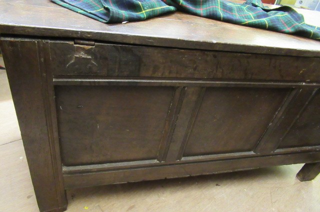 AN OAK PANELLED COFFER Image