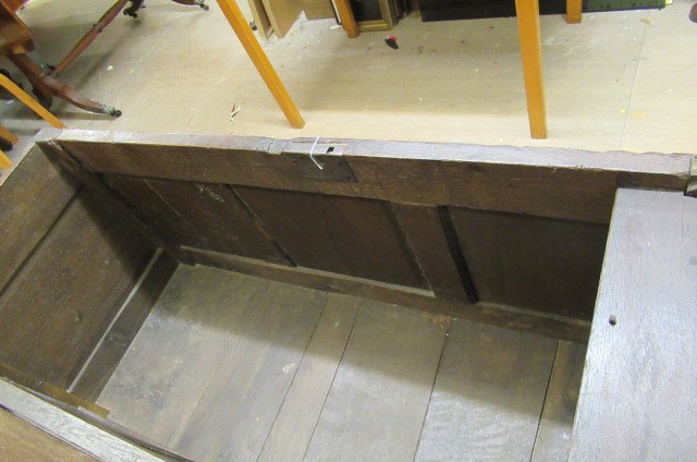 AN OAK PANELLED COFFER Image