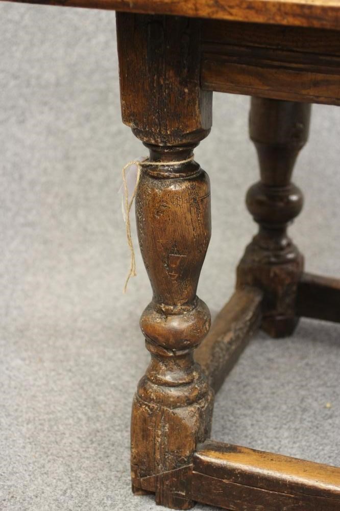 A JOINED OAK DINING TABLE Image