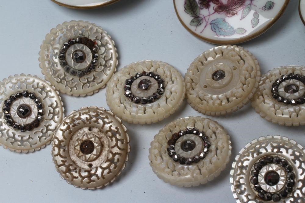 A SET OF NINE GEORGIAN MOTHER OF PEARL BUTTONS carved and pierced with vermiculae and set with cut Image