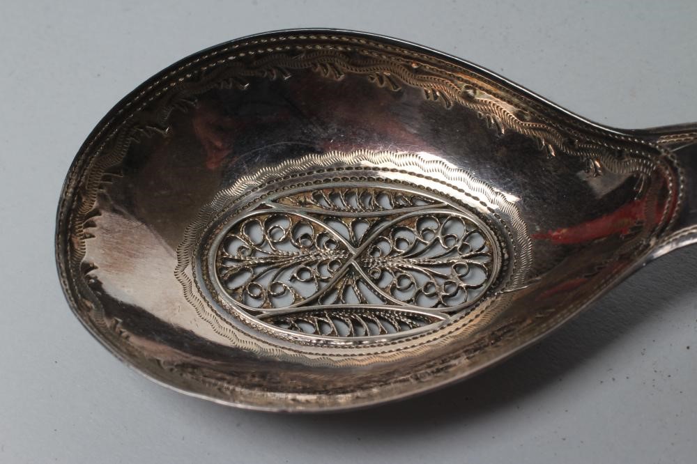 A LATE GEORGE III SILVER CADDY SPOON Image