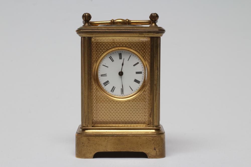 A MINIATURE BRASS CASED CARRIAGE CLOCK Image