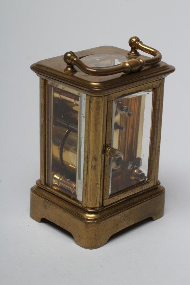 A MINIATURE BRASS CASED CARRIAGE CLOCK Image