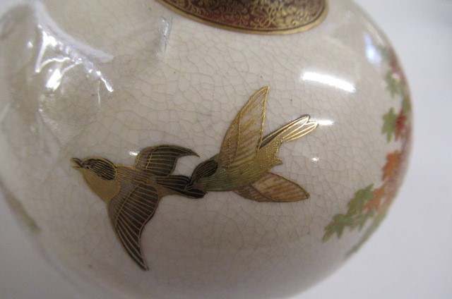 A SATSUMA EARTHENWARE SMALL VASE of bombe cylindrical form painted in shades of orange and green Image