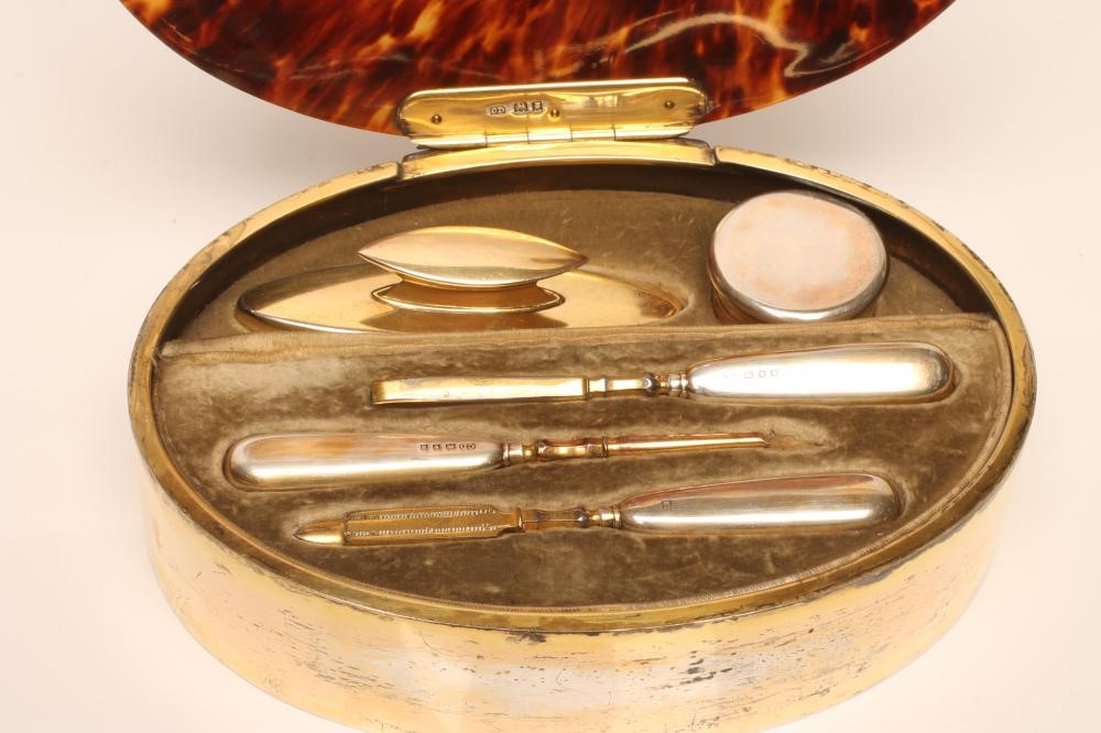AN ART DECO SILVER GILT MOUNTED TORTOISESHELL CASED MANICURE SET Image