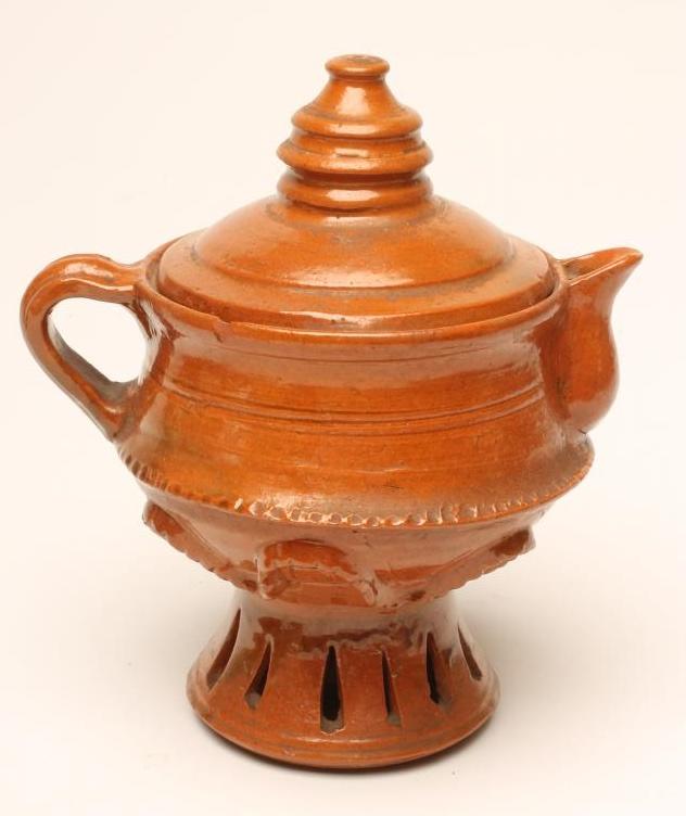 A GLAZED TERRACOTTA JUG AND COVER Image