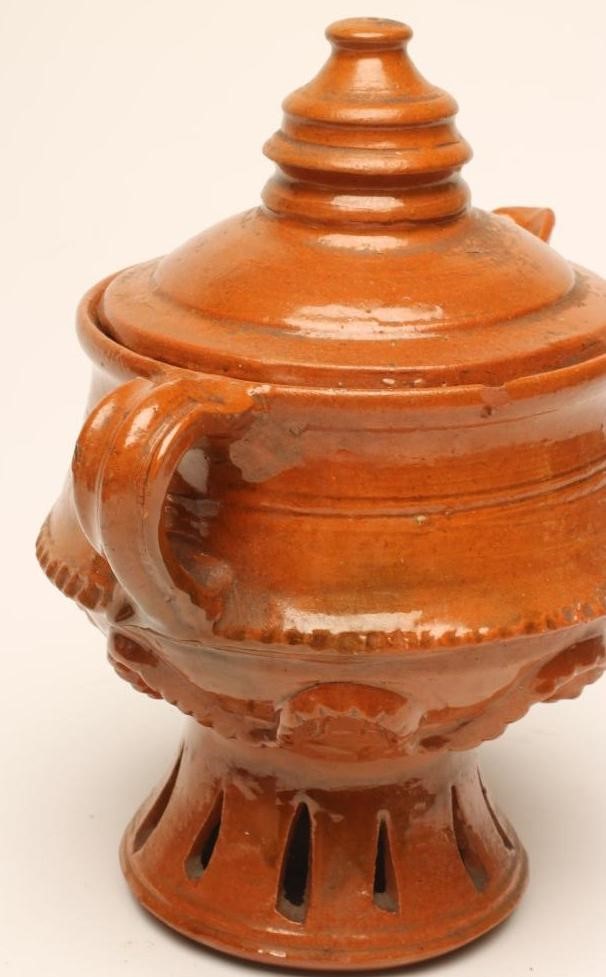 A GLAZED TERRACOTTA JUG AND COVER Image