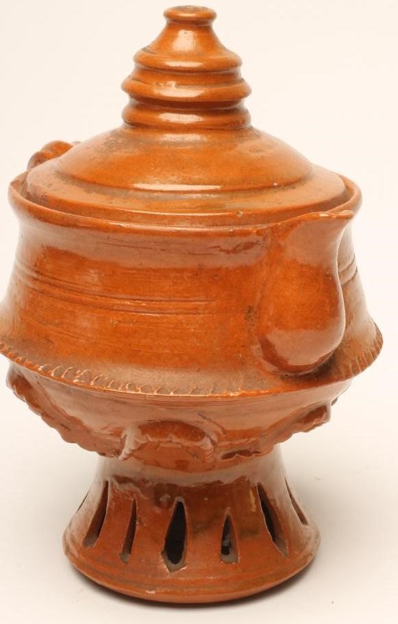 A GLAZED TERRACOTTA JUG AND COVER Image