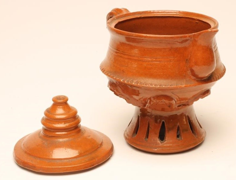 A GLAZED TERRACOTTA JUG AND COVER Image