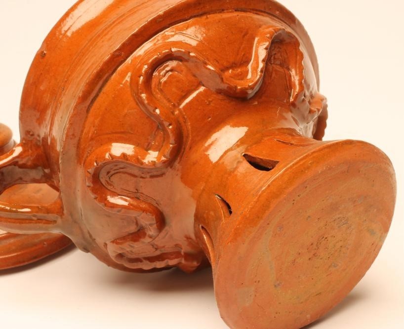 A GLAZED TERRACOTTA JUG AND COVER Image