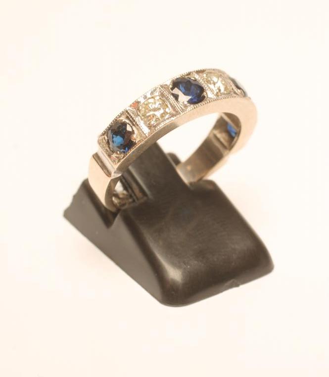 A SAPPHIRE AND DIAMOND HALF HOOP ETERNITY RING Image