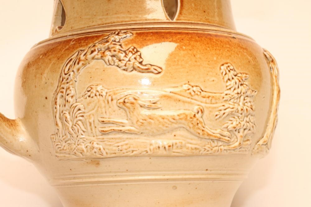 A SALTGLAZE STONEWARE PUZZLE JUG Image