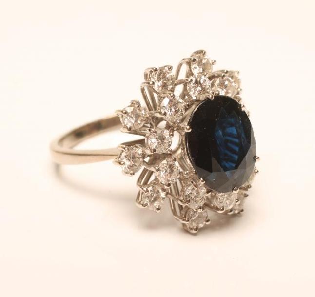 A SAPPHIRE AND DIAMOND CLUSTER RING Image