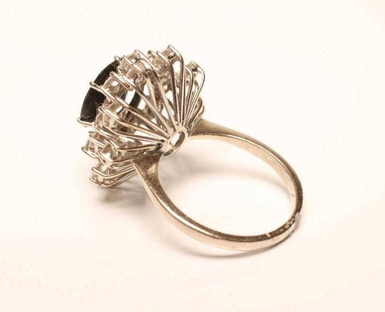 A SAPPHIRE AND DIAMOND CLUSTER RING Image