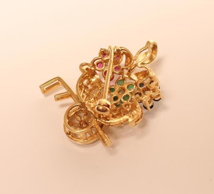 A NOVELTY BROOCH modelled as a flower stall with a sapphire Image