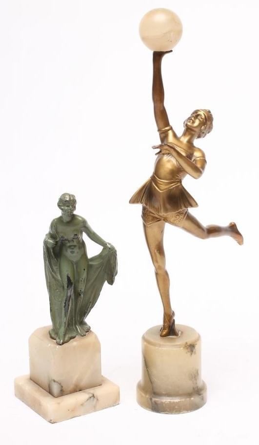 AN ART DECO BRONZED SPELTER FIGURE of a young lady wearing a flared top over shorts Image