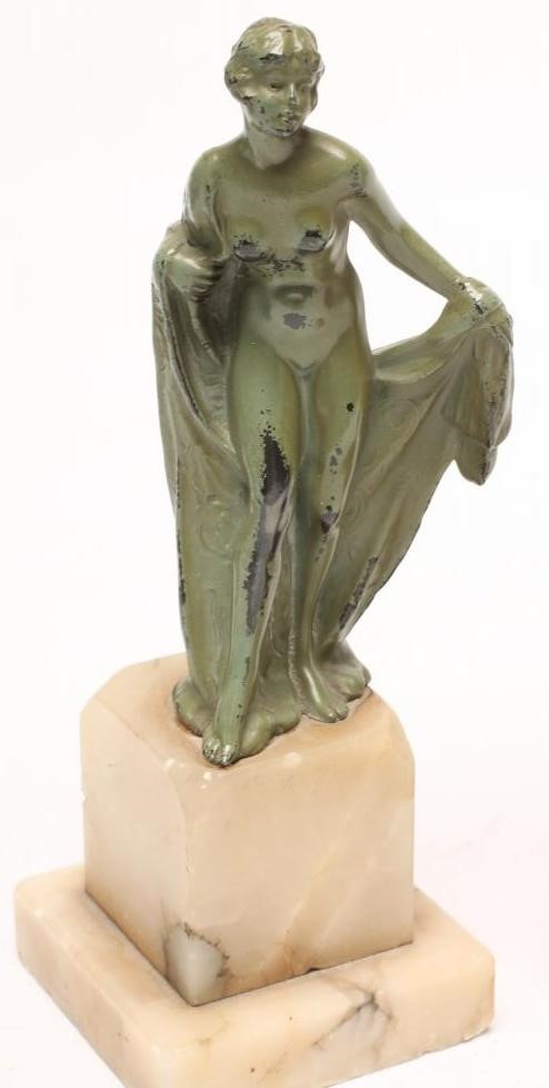 AN ART DECO BRONZED SPELTER FIGURE of a young lady wearing a flared top over shorts Image
