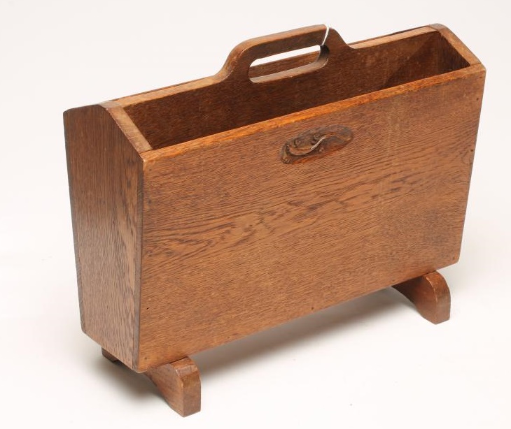 A SMALL OAK MAGAZINE RACK by Martin Dutton Image