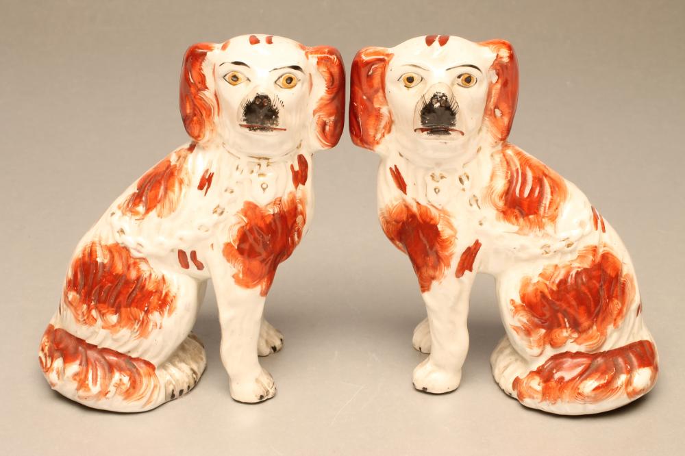 A PAIR OF VICTORIAN STAFFORDSHIRE POTTERY SMALL SPANIELS Image