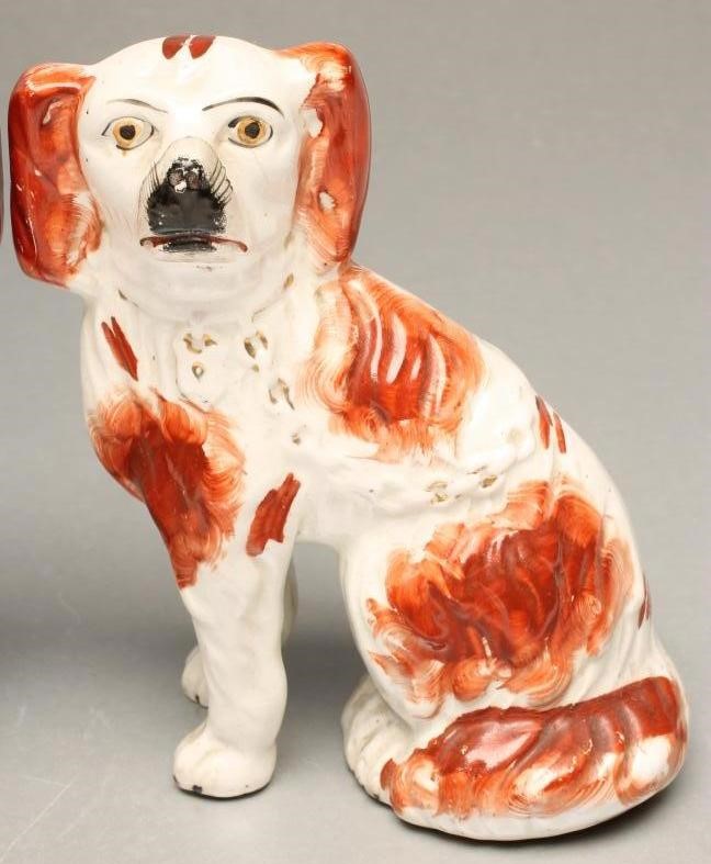 A PAIR OF VICTORIAN STAFFORDSHIRE POTTERY SMALL SPANIELS Image