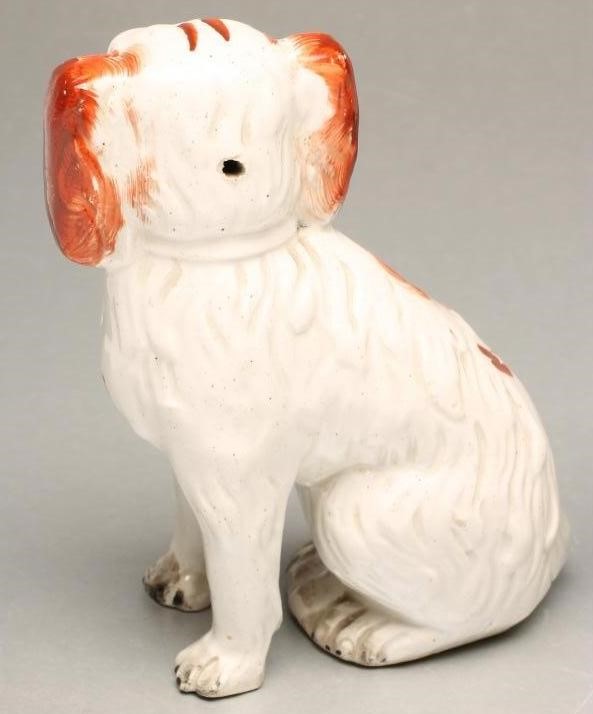 A PAIR OF VICTORIAN STAFFORDSHIRE POTTERY SMALL SPANIELS Image