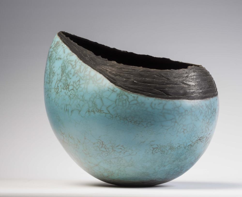 ‡HILARY SIMMS (Contemporary) - A large pale turquoise glazed raku fired stoneware oval vessel from Image