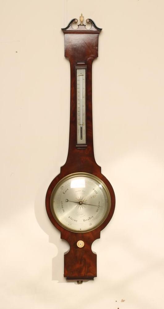 A MAHOGANY WHEEL BAROMETER signed Elliot Bros. Image