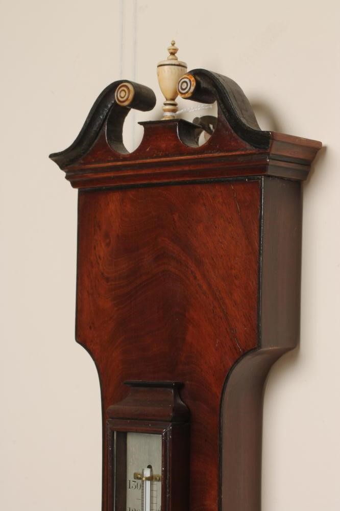 A MAHOGANY WHEEL BAROMETER signed Elliot Bros. Image