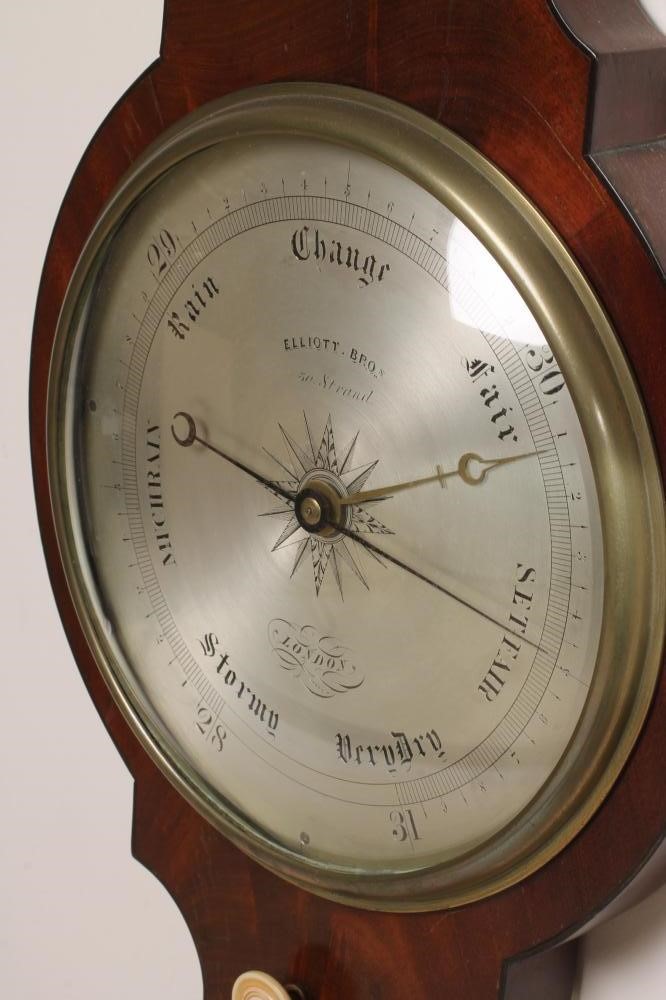 A MAHOGANY WHEEL BAROMETER signed Elliot Bros. Image
