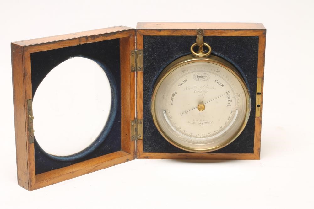 A BRASS CASED ANEROID BAROMETER by Negretti & Zambra Image