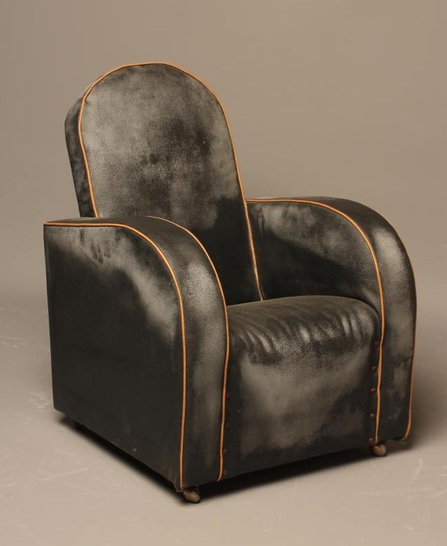 A CHILD'S ART DECO ARM CHAIR upholstered in black leatherette with cafe au lait piping Image