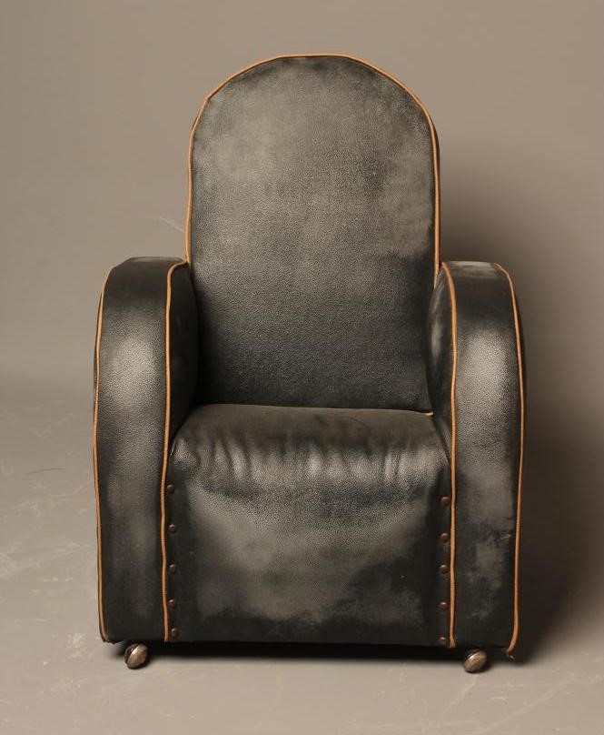 A CHILD'S ART DECO ARM CHAIR upholstered in black leatherette with cafe au lait piping Image