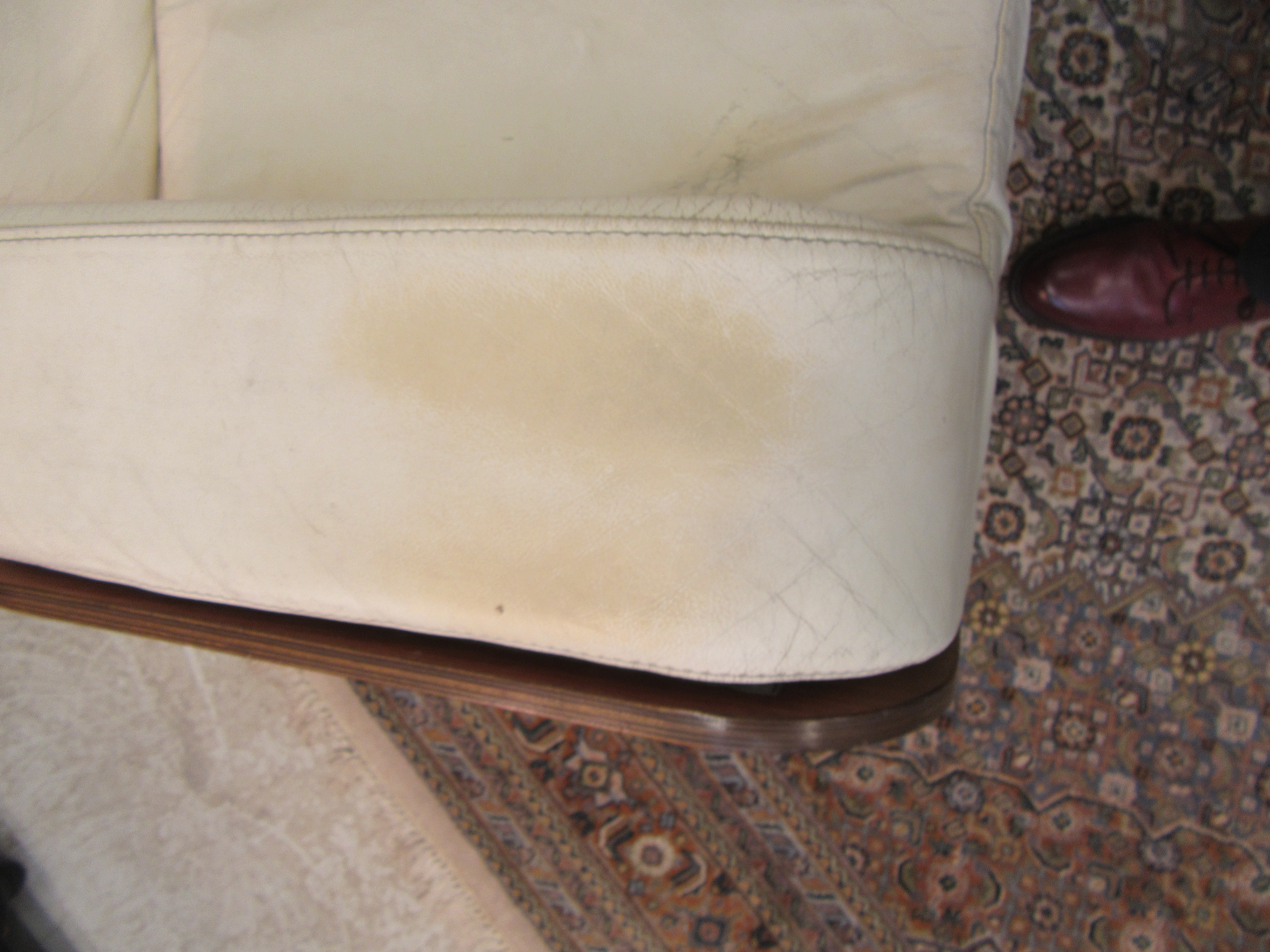 A MOULDED VENEERED ROSEWOOD ARMCHAIR with shaped cream leather cushion Image